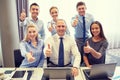 Business people showing thumbs up in office Royalty Free Stock Photo