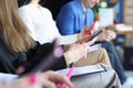 Business people sitting at conference and holding documents and mobile phones in hands closeup Royalty Free Stock Photo