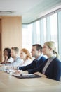 Business people sitting at conference table during meeting Royalty Free Stock Photo