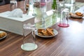 Business people sitting on a table for conference with cookies glass and jar of water placed on wooden table Royalty Free Stock Photo