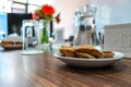 Business people sitting on a table for conference with cookies glass and jar of water placed on wooden table Royalty Free Stock Photo