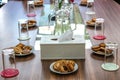 Business people sitting on a table for conference with cookies glass and jar of water placed on wooden table Royalty Free Stock Photo