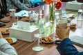 Business people sitting on a table for conference with cookies glass and jar of water placed on wooden table Royalty Free Stock Photo