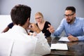 Business People Conducting Job Interview Looking At Applicant