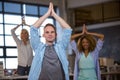 Business people smiling while practicing yoga Royalty Free Stock Photo