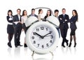 Business people stand near big alarm clock Royalty Free Stock Photo