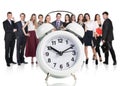 Business people stand near big alarm clock Royalty Free Stock Photo