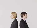 Business people Standing Back To Back On Gray Background Royalty Free Stock Photo