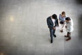 Business people standing in business building and having convers