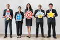 Business people standing and holding icons Royalty Free Stock Photo