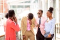 Business people standing next to a classic office building and laughing Royalty Free Stock Photo