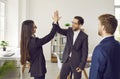 Business people standing in office making a deal. Man giving high five to a woman finishing meeting Royalty Free Stock Photo