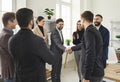 Business people standing in office making successful deal. Two men shaking hands finishing meeting. Royalty Free Stock Photo