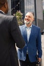 Business people standing and shake hands in front of modern office Royalty Free Stock Photo