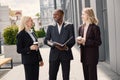 Business people standing and talk to each other in front of modern office Royalty Free Stock Photo