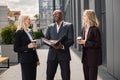 Business people standing and talk to each other in front of modern office Royalty Free Stock Photo