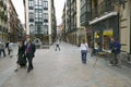 Business people take lunchtime walk as painter paints in Bilbao (Bilbo), the North Coast of Spain