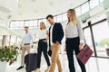 Business people talk and walk together with luggage