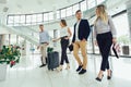 Business people talk and walk together with luggage