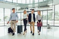 Business people talk and walk together with luggage