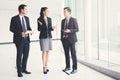 Business people talking and discussing work in building hallway