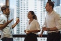 Business people talking and holding cups of coffee with city view .Group of coworkers having a coffee break in office Royalty Free Stock Photo