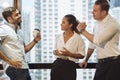 Business people talking and holding cups of coffee with city view .Group of coworkers having a coffee break in office. Royalty Free Stock Photo