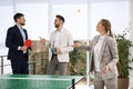 Business people talking near ping pong table in office Royalty Free Stock Photo