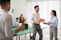 Business people talking near ping pong table in office Royalty Free Stock Photo