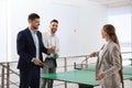 Business people talking near ping pong table in office Royalty Free Stock Photo