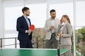 Business people talking near ping pong table in office Royalty Free Stock Photo