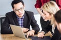 Business people talking together look at computer laptop in meeting Royalty Free Stock Photo