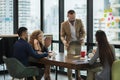 Business people team colleagues in modern office. Man and woman meeting conference and presentation in room Royalty Free Stock Photo