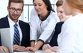 Business people team at meeting in office. Focus at business woman pointing into laptop. Teamwork or coaching concepts Royalty Free Stock Photo