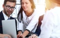 Business people team at meeting in office. Focus at business woman pointing into laptop. Teamwork or coaching concepts Royalty Free Stock Photo