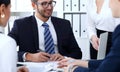 Business people team at meeting in office. Focus at business woman pointing into laptop. Teamwork or coaching concepts Royalty Free Stock Photo