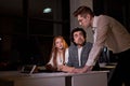 Business people team working late night using computer. Overtime hours concept. Royalty Free Stock Photo