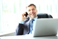 Business, people and technology concept - happy smiling businessman with laptop computer office Royalty Free Stock Photo