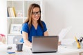 Happy woman with laptop working at home or office Royalty Free Stock Photo