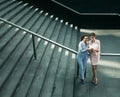 Business, people, tehnology and lifestyle concept: Two business women with mobile near stairs Royalty Free Stock Photo