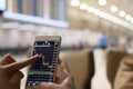 business people trading forex stock exchange on mobile at airport view with bokeh, selective focus , finance concept.