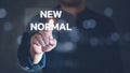 Business people use their fingers to touch the word `New normal`. Business concept for Make a big dramatic change Replace the ex Royalty Free Stock Photo