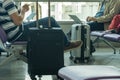 Business people using laptop at departure waiting lounge at airport