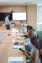 Business people using laptop and digital tablets at conference table during meeting Royalty Free Stock Photo