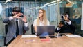 Business people using virtual reality goggles during meeting. Team of developers testing virtual reality headset and Royalty Free Stock Photo