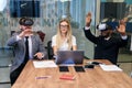 Business people using virtual reality goggles during meeting. Team of developers testing virtual reality headset and Royalty Free Stock Photo