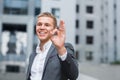 Business, people, vision and success concept - happy smiling businessman in eyeglasses and suit showing ok sign over office buildi Royalty Free Stock Photo