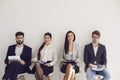 Business people waiting for job interview recruitment sitting on a chair in the office. Royalty Free Stock Photo