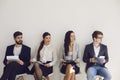 Business people waiting for job interview recruitment sitting on a chair in the office. Royalty Free Stock Photo