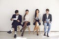 Business people waiting for job interview recruitment sitting on a chair in the office. Royalty Free Stock Photo